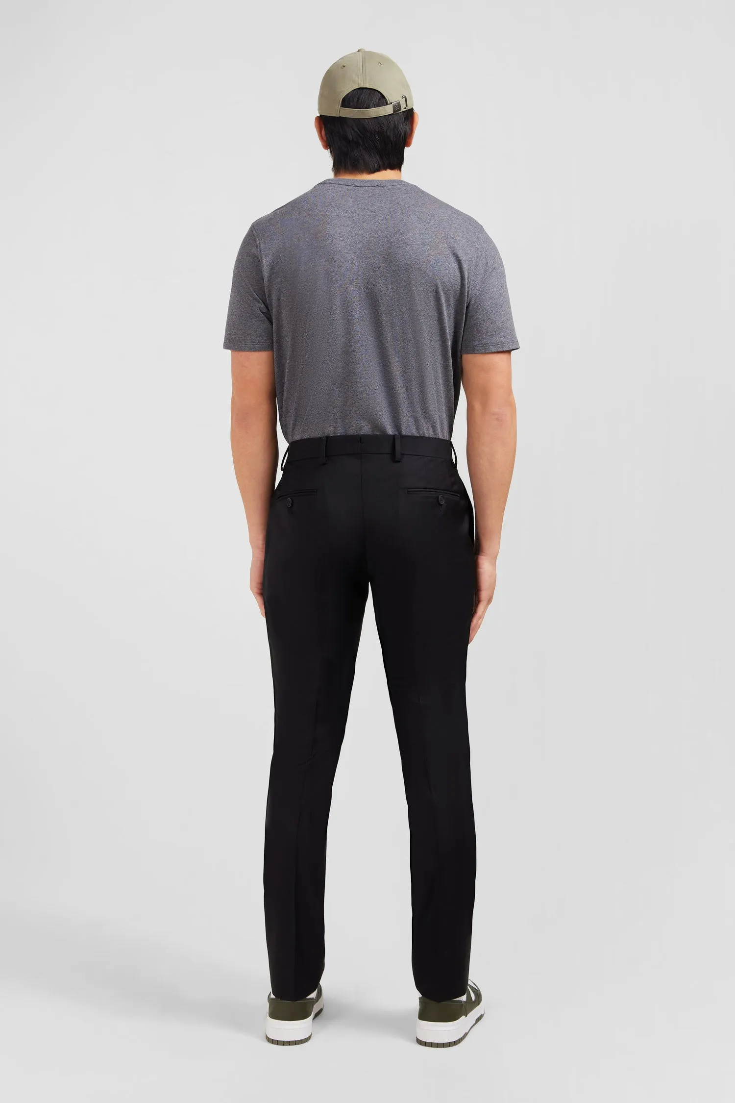 Slim black wool trousers with broken fold